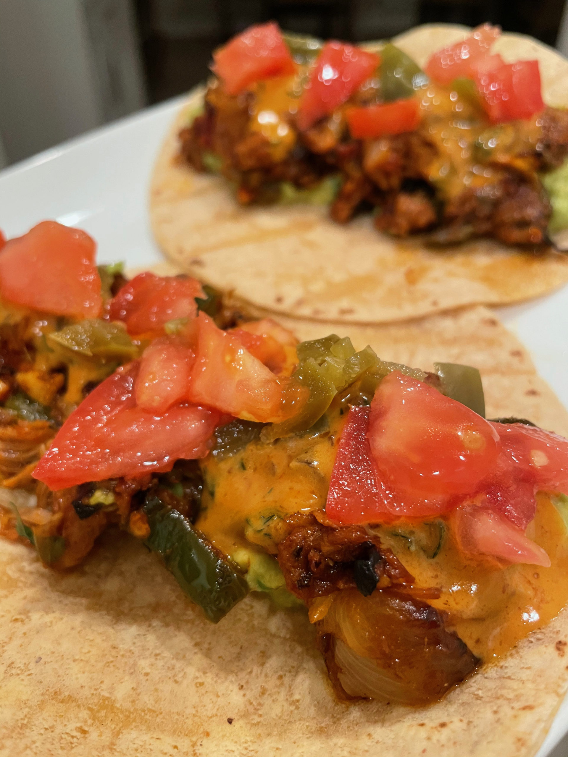 You can top your jackfruit tacos with tomatoes and a vegan chipotle aioli.