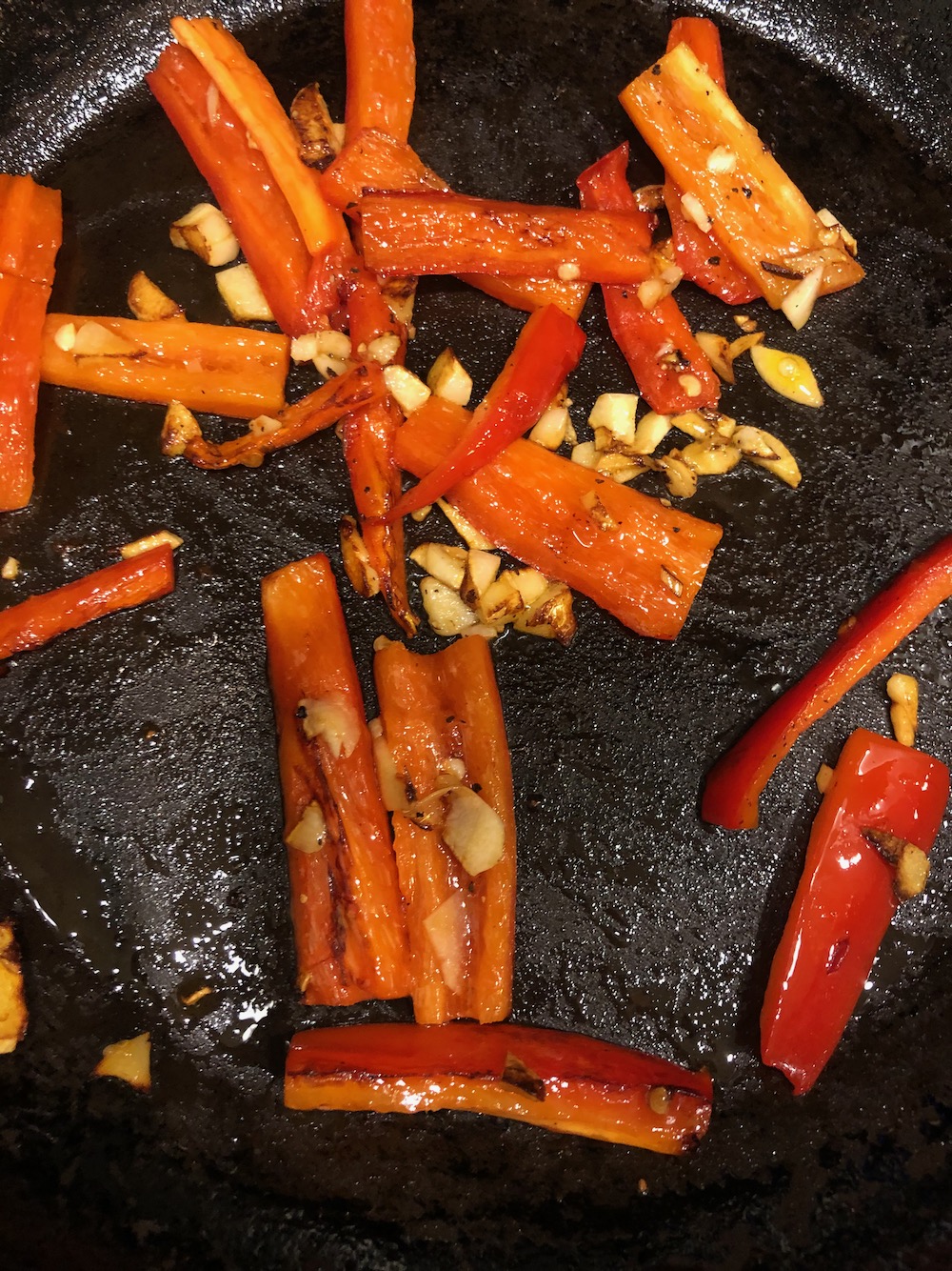 Sautéing the red pepper with garlic.