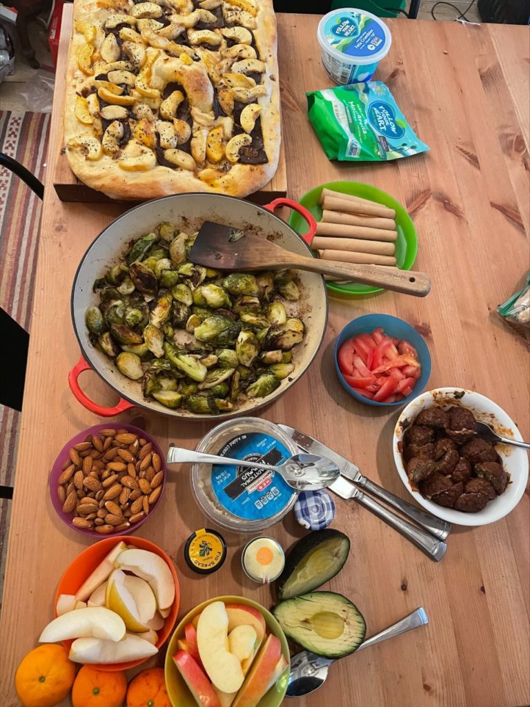 A delightful vegan spread Ian made with his homemade focaccia, vegan meatballs, roasted Brussels sprouts and so much more.